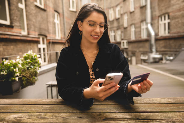 istock Young woman using smartphone to buy online 1711740207