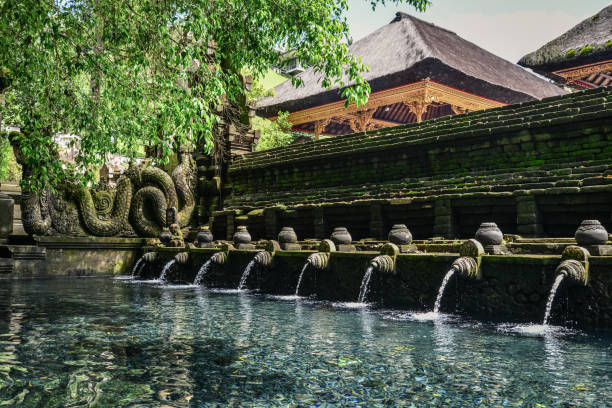 Holy spring water of sacred pool at Pura Tirta Empul Temple, Tampaksiring, Bali, Indonesia.
