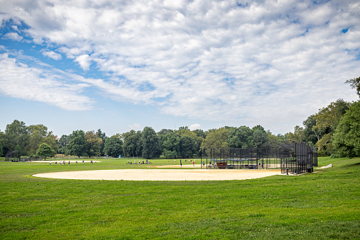 Baseball field with fence surrounded by lush greenery at the Eola Community Center in Aurora, Illinois