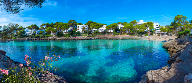 Panoramic view of Cala Petita beach in Cala d'Or coastline, with  crystal clean transparent water on a sunny summer day on Majorca Balearic Islands