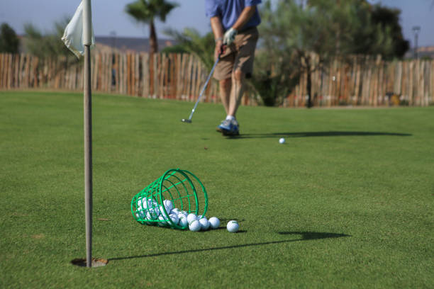 istock Golf Swing Elegance: Golfer's Feet, Fallen Basket, and Flag's Shadow 1711751749