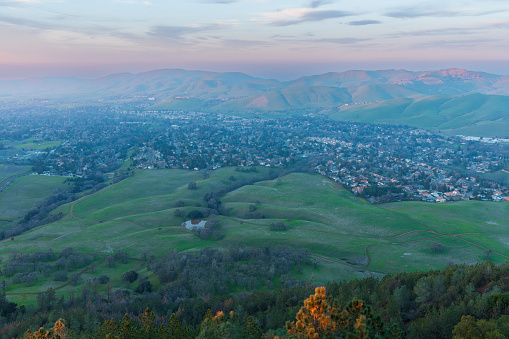 Hazy sunset over Clayton and Mitchell Canyon from Mt. Diablo State Park. Contra Costa County, California, USA.