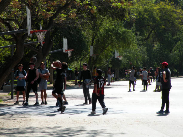 Young people playing basketball in the OHiggins Park, Santiago, Chile