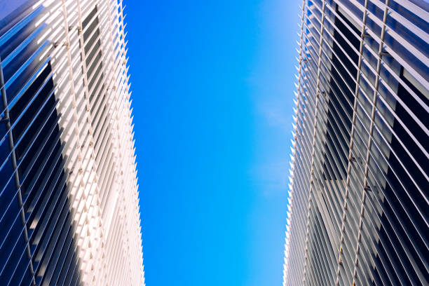 istock Two buildings converging on a blue sky background in the center. 1711774354