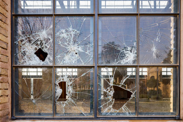 istock Stoned window with broken glass of an industry. 1711789608