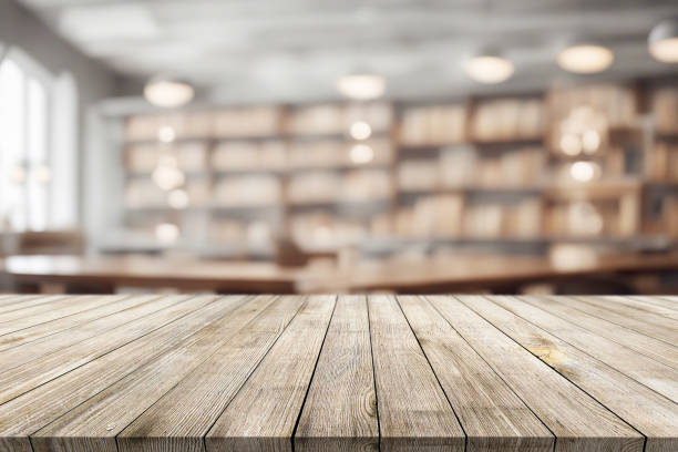 istock Beautiful natural wooden table with library background 1711791358