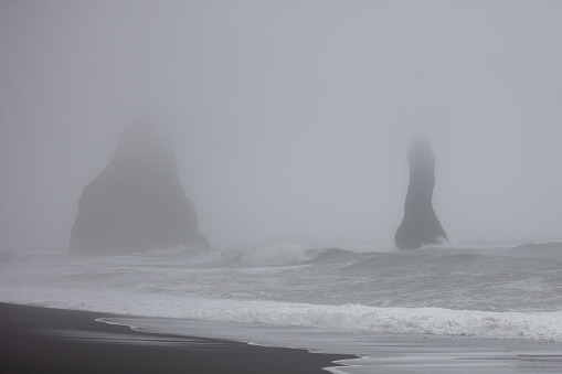 Black sand beach from Iceland in rainy day.
