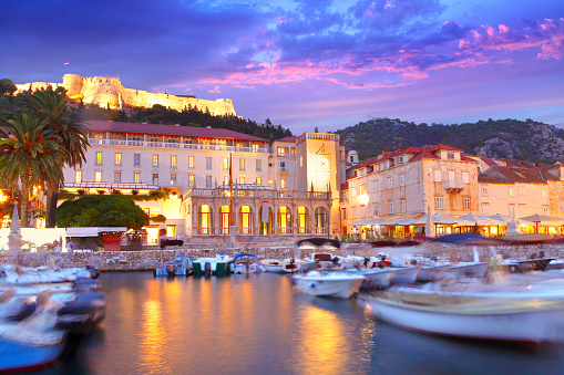 Spanish Fortress on the hill and the Hvar town centre with port by twilight