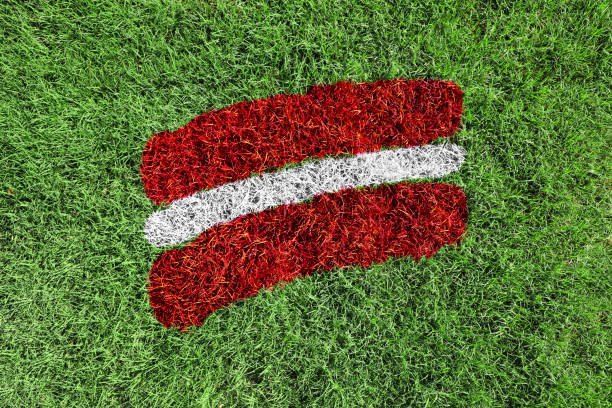 istock Latvia flag colors painted on grass field 1711802299