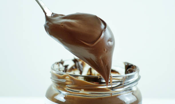 istock cream chocolate on spoon on white background 1711819595