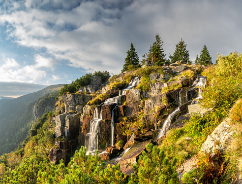 Morning landscape of mountains with waterfall. Pancava waterfall in Karkonosze national park in Czech republic. Summer sunny landscape.