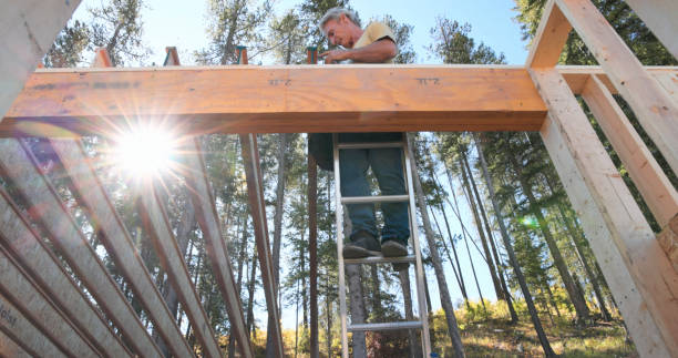 istock Mature man prepares roof beams 1711830970