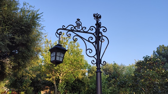 Traditional style street light and the tops of buildings in old Amsterdam