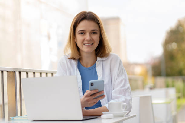 istock Young smiling caucasian woman using mobile phone chatting, 1711856553