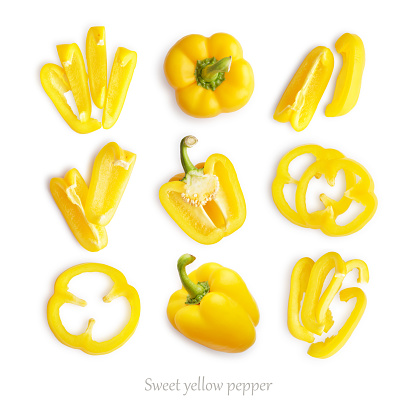 Set of fresh whole and sliced sweet yellow pepper isolated on white background, top view