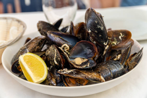istock Steamed mussels with lemon, served on a white plate 1711905446