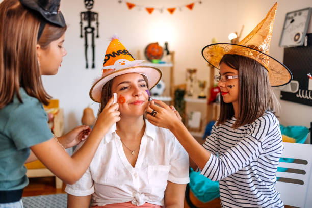 Family having fun at home with decorating for Halloween night