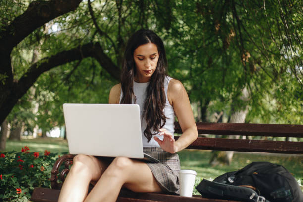istock Woman using a laptop outdoors stock photo 1711917109