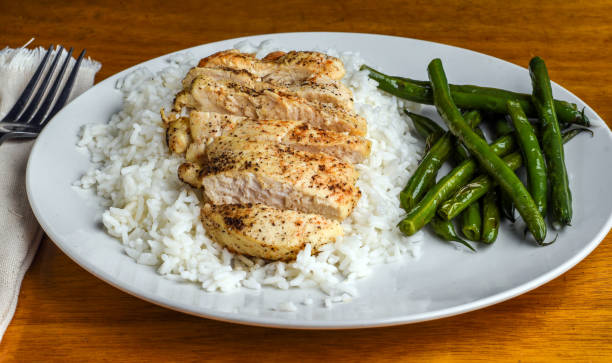 istock seasoned chicken breast  on rice  served with green beans 1711925540