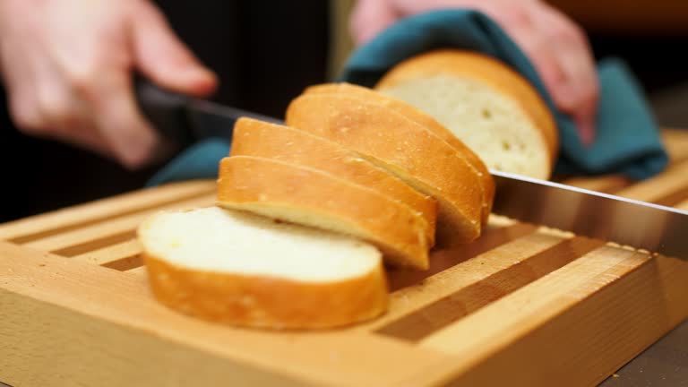 Frame of freshly baked bread sliced on a wooden board. Loaf of bread, piece of food, healthy eating concept.