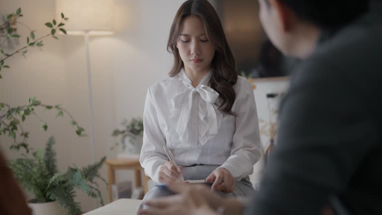 Asian professional psychologist concentrate listening to senior mental health while meeting at room.