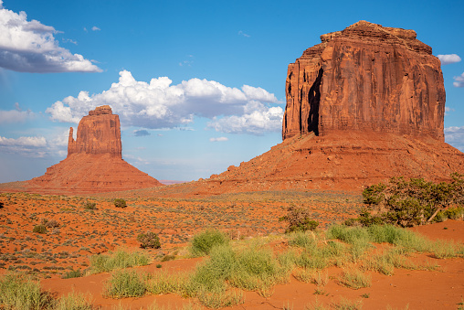 Monument Valley, on the Arizona - Utah border, gives us some of the most iconic and enduring images of the American Southwest.  The harsh empty desert is punctuated by many colorful sandstone rock formations.  It can be a photographer's dream to capture the ever-changing play of light on the buttes and mesas.  Even to the first-time visitor, Monument Valley will probably seem very familiar.  This rugged landscape has achieved fame in the movies, advertising and brochures.  It has been filmed and photographed countless times over the years.  If a movie producer was looking for a landscape that epitomizes the Old West, a better location could not be found.  This picture of the rock formations in the evening light was photographed from the Monument Valley Road north of Kayenta, Arizona, USA.