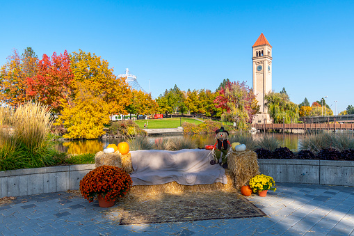 Seasonal autumn and Halloween decorations at the public Riverfront Park along the Spokane River with the pavilion and clock tower in view in Spokane, Washington USA. Riverfront Park, branded as Riverfront Spokane, is a public urban park in downtown Spokane, Washington that is owned and operated by the Spokane Parks & Recreation Department.