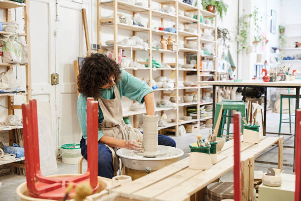 istock Craftswoman making clay vase in pottery studio 1712016936