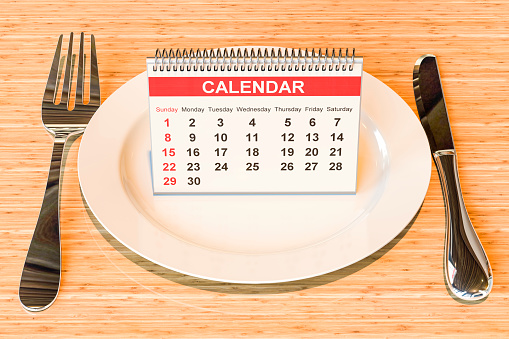 Dinner plate with desk calendar, 3D rendering