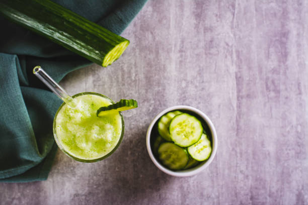 istock Fresh cucumber lemonade in a glass on the table top view 1712037437