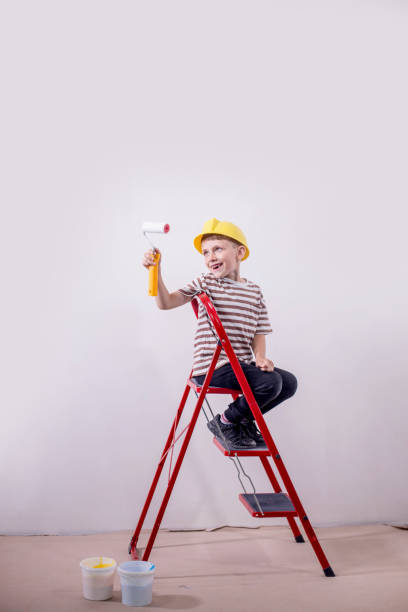 istock Boy painting wall during home renovation 1712049097