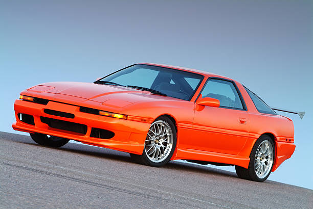 Orange Turbo Sports Car Tangelo orange, turbocharged sports car/tuner car with 18-inch wheels, body kit and aluminum wing. Fuji S2 Pro, 80-200mm lense, tripod. street racing stock pictures, royalty-free photos & images