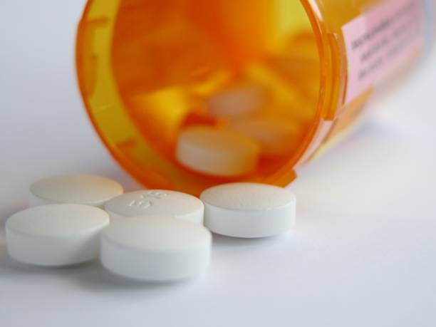istock White pills spill from medicine bottle 171205700