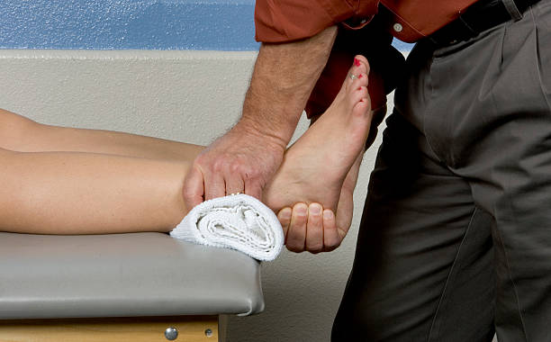 Physical therapist working on a woman's ankle stock photo
