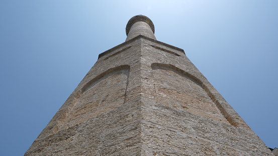 Vertical low angle view of minaret against blue sky