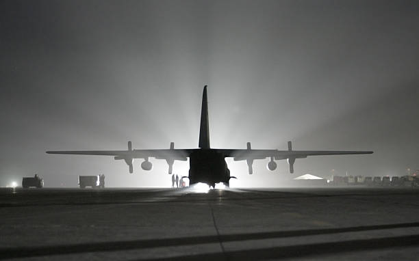 Iraqi C-130 "A silhouette of an Iraqi C-130 sitting on a runway in Baghdad, Iraq." military deployment photos stock pictures, royalty-free photos & images