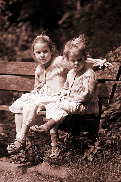 istock Two girls in on a bench, quietly observing 171206370