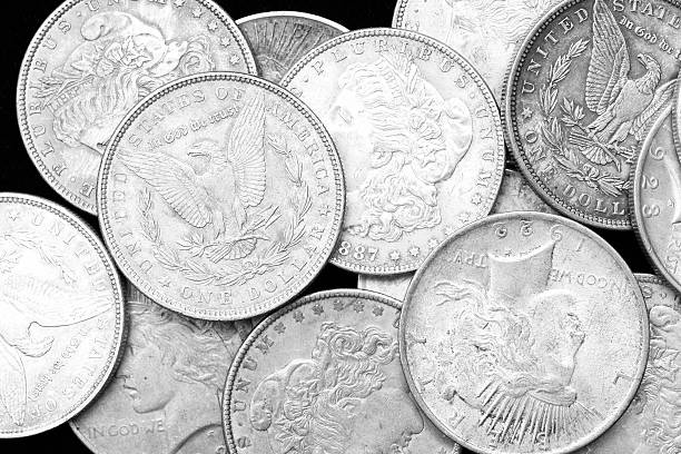 US Silver Dollars on black background Very detailed photograph of actual US Silver Dollars on pure black background coin collection stock pictures, royalty-free photos & images