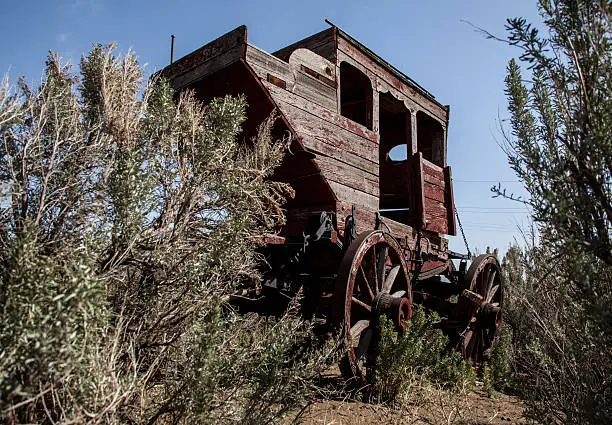 Photo of Antique Stage Coach With Desert Foliage Wide Clear Blue Sky