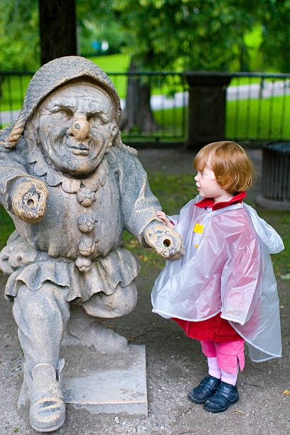 istock girl admiring dwarf statue 171208824