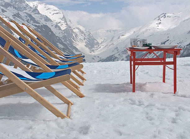 istock Row of reclining chairs  with table in snowy mountains 171209387