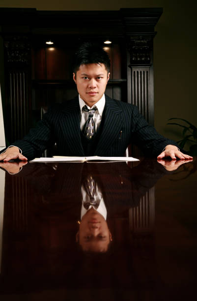 Young Asian Business Man young man (twenty) sitting at a conference table with a reflection modelkt stock pictures, royalty-free photos & images