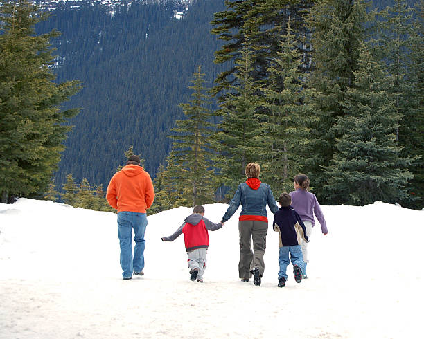 Family of five walking in snow