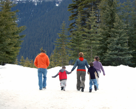 Family of five walking in snow
