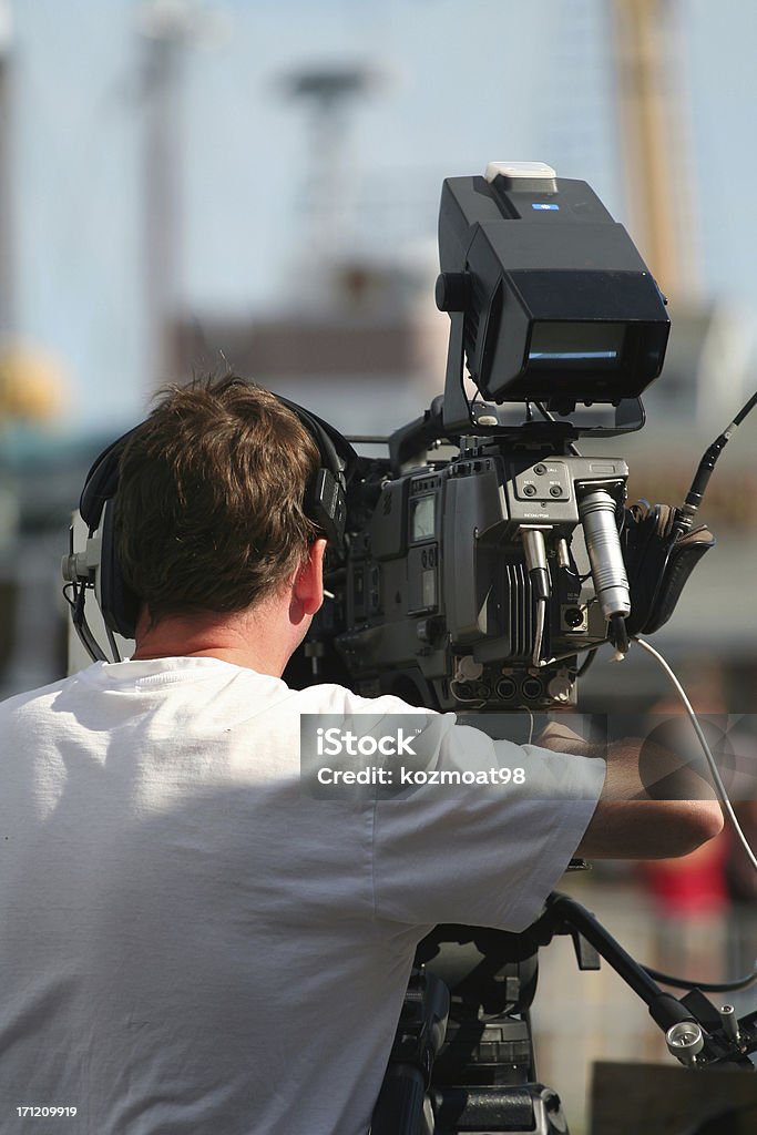 Television Camera Man Operating Equipment Television camera man operating equipment.Shot shallow dof. Adult Stock Photo