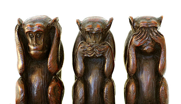 three wise monkeys stock photo