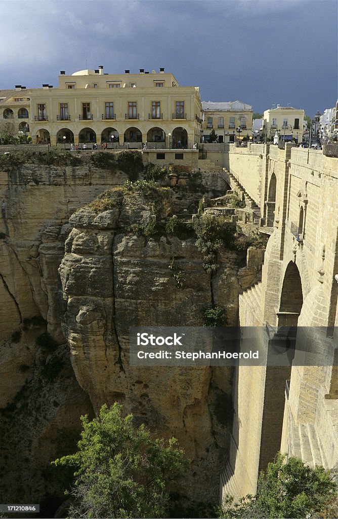 Parador in Ronda, Spain A view into the canyon with the bridge on the right. The parador is the prominent building at the top. Andalusia Stock Photo