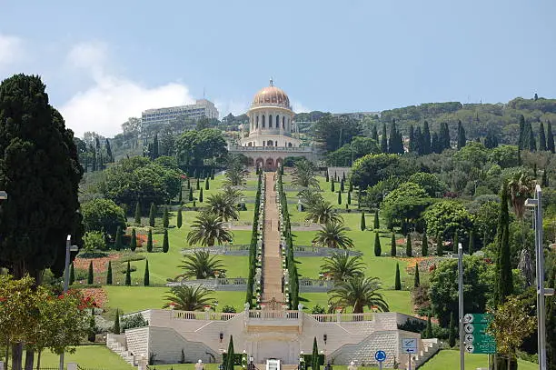"Bahai Gardens in Haifa, Israel.  The gold domed Shrine of the Bab is visibile at the top of the image, with many terraces and steps below it."