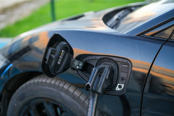 istock plugged into electric car power cord to charge 1712118596