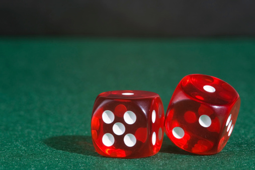 Red Las Vegas Casino style dice on green felt. Room for copy